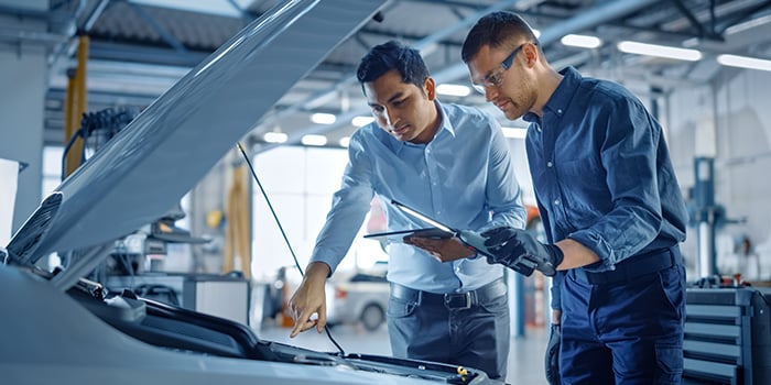 Service technicians diagnosing a vehicle